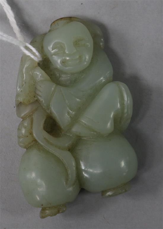 A green jade carving of boy with fruit